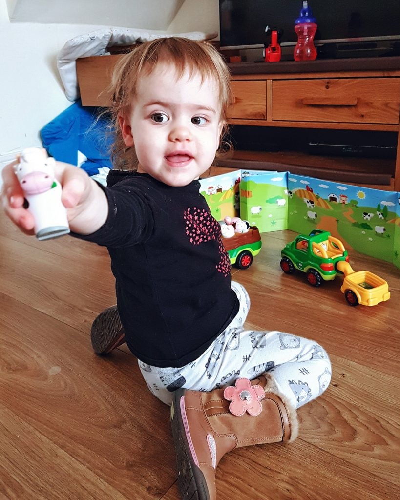 Little girl plays with WOW toys Jessie Farm Jeep and Freddie Farm Truck. Photo by Someone's Mum