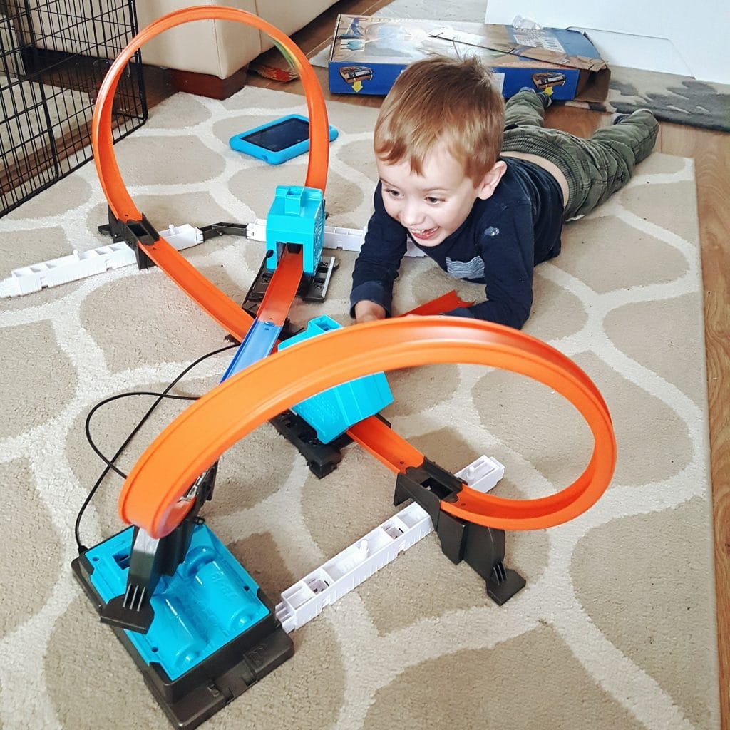 Boy plays with Hot Wheels Track Builder System. Photo by Someone's Mum